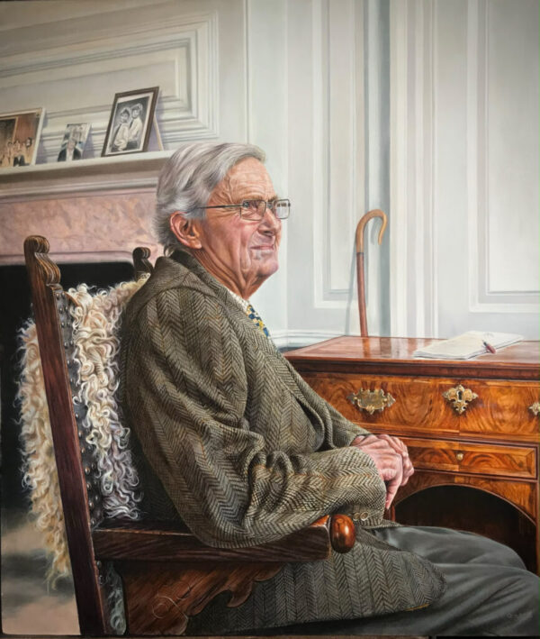 Elderly man sitting with cane.